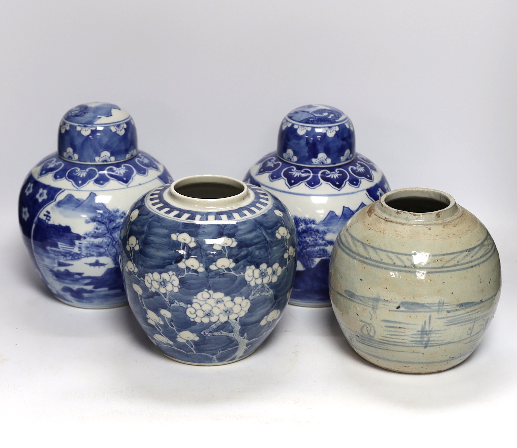 Four Chinese ginger jars, including a blue and white pair with covers and a prunus flower example, largest 21cm high